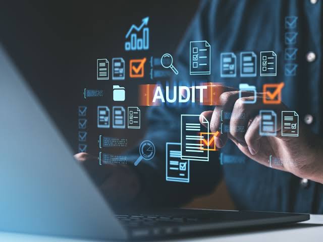 A business audit visualised over a laptop with checklists and charts